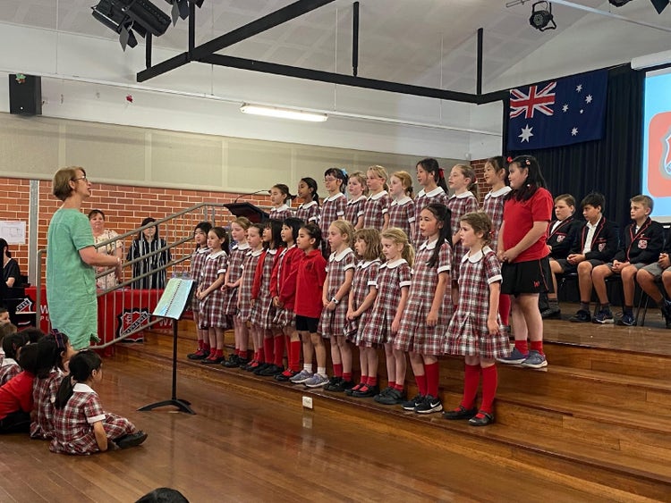 A group of children in a classroom Description automatically generated