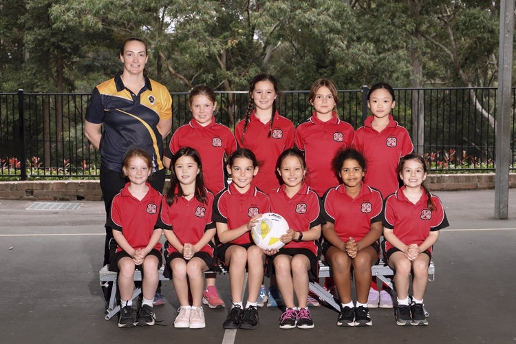 A group of girls in red uniforms Description automatically generated